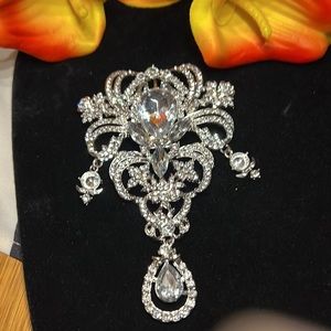 BRAND NEW …. BROOCH ENCRUSTED WITH COLORLESS STONES. BRILLIANT!!